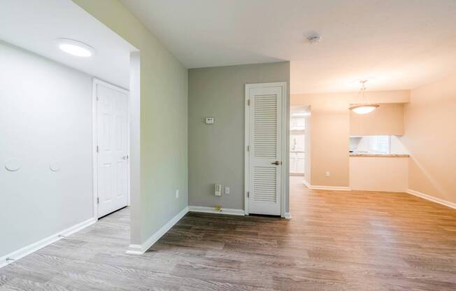 A room with a white door and a grey floor.