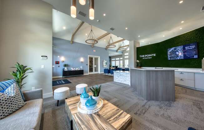 a lobby with a reception desk and a table with chairs