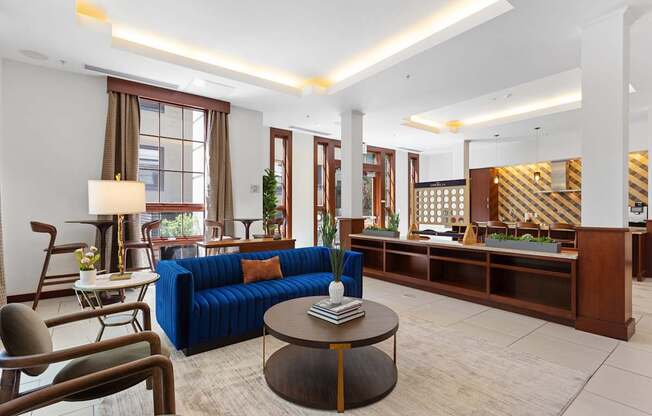 a lobby of a hotel with a blue couch and a coffee table