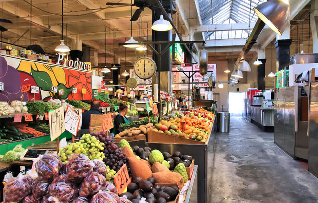 A produce section of a market with a variety of fruits and vegetables.