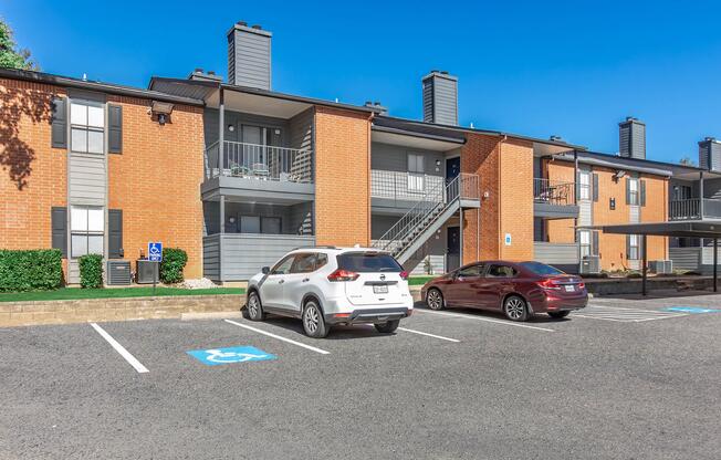 a car parked in a parking lot in front of a brick building