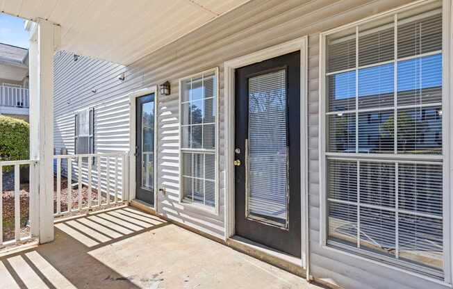 A white house with a black door and window.