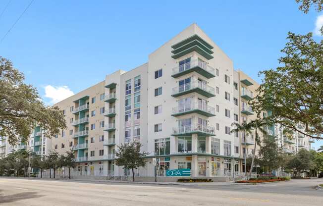 a white apartment building with a street in front of it