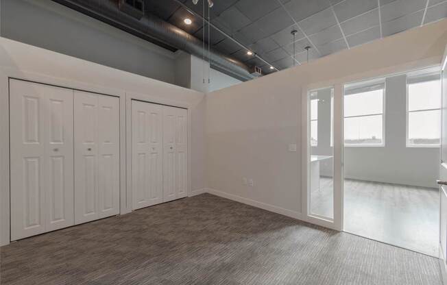 A room with a grey carpet and white walls.