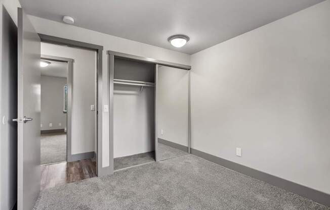 A room with a carpeted floor and a white wall.
