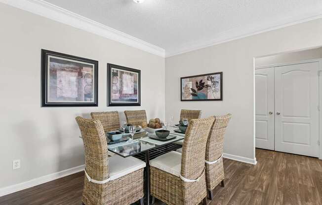 A dining room with a glass table and chairs.