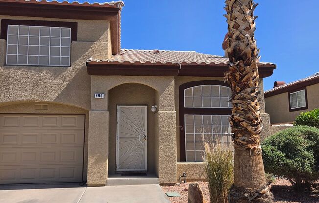 Two story 2 bedroom townhome with newer flooring, paint & appliances - community pool!