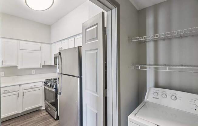A white kitchen with a refrigerator, oven, and dishwasher.