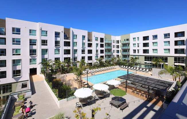A large white building with a pool in the middle of it.
