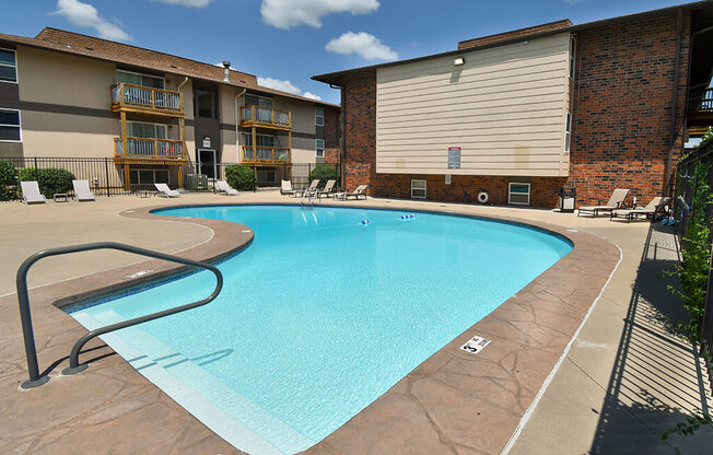 a swimming pool with a building in the background