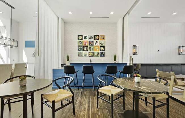 A room with a white wall and a blue couch.