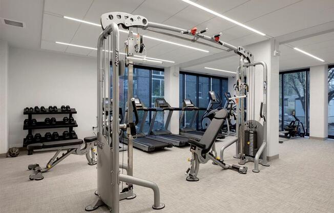 Fitness center with large windows and cable machine