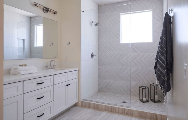 a white bathroom with a shower and a sink and a mirror at Novella Biltmore, Arizona