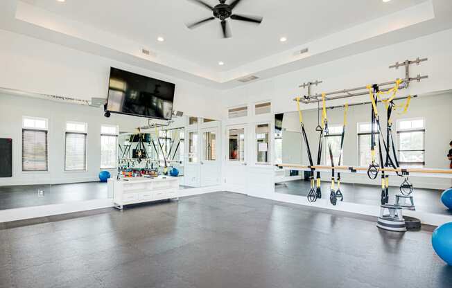 a home gym with weights and a tv on the wall