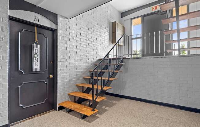 A black door with a sign that says "HOME" on it.