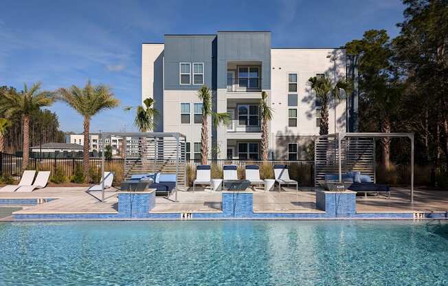 A modern building with a pool in front.