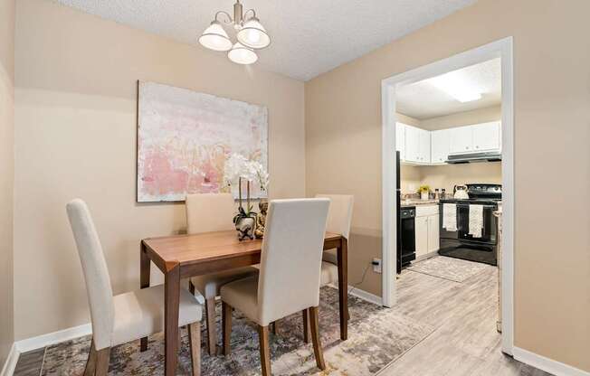 A dining room with a wooden table and chairs.