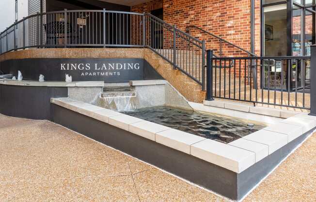 the fountain in front of the kings landing apartments building