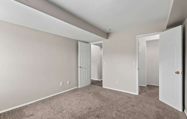 Bedroom with a carpeted floor and two doors at Creve Coeur, Creve Coeur, MO