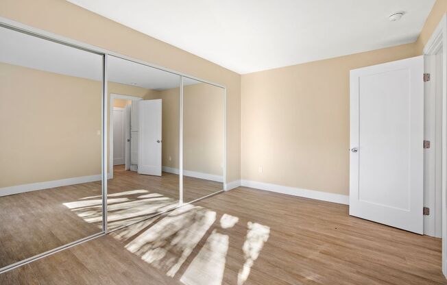Marina Del Rey apartments bedroom with mirrored closet doors.