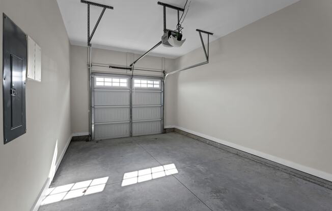 an empty garage with a white wall and a garage door