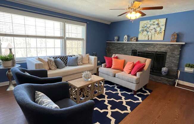 Living room with seating and fireplace at Barracks West in Charlottesville, VA