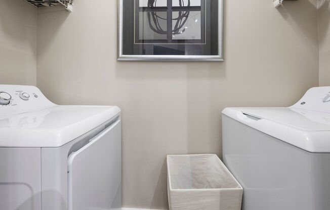 a washer and dryer in a laundry room with a window