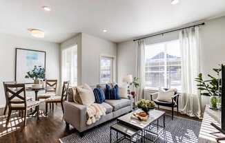 A living room with a grey couch and a coffee table.