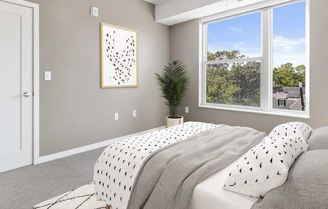 A bedroom with a large bed and a picture on the wall.