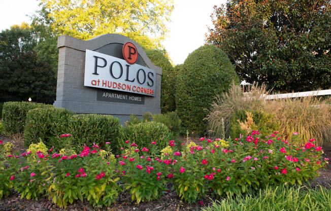 Entrance Signage with flowers at Polos at Hudson Corners Apartments, South Carolina 29650