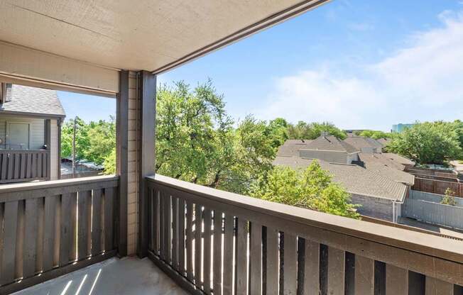 A balcony with a view of a residential area.