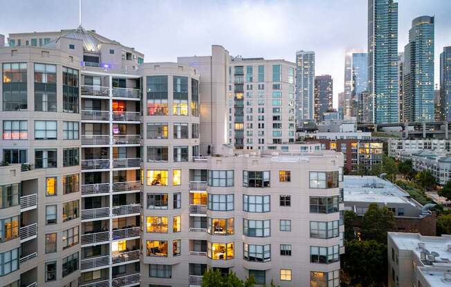 A cityscape with apartment buildings in the foreground and skyscrapers in the background.