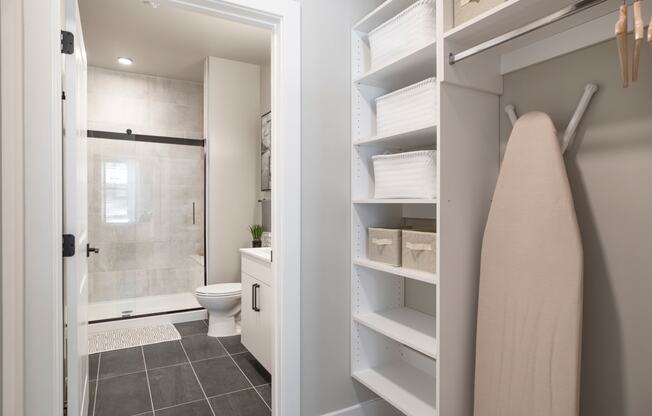 a bathroom with a shower and a towel rack in a closet