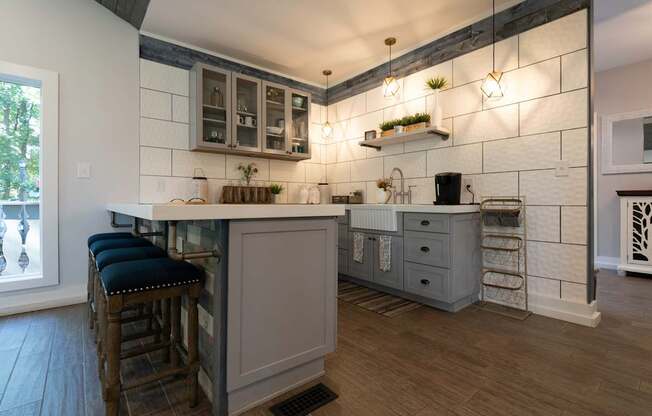 A kitchen with a bar area and a window.