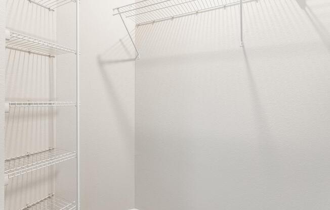 A white refrigerator with empty shelves.