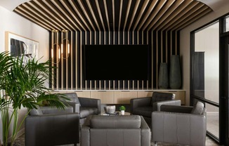 a living room with couches and a tv on the wall at Esplanade District Apartments, Little Rock, Arkansas