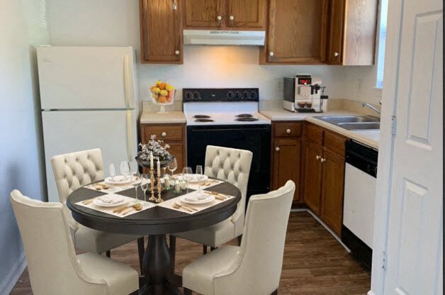 a kitchen and dining room with a table and chairs