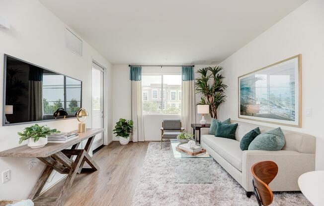 a living room filled with furniture and a large window