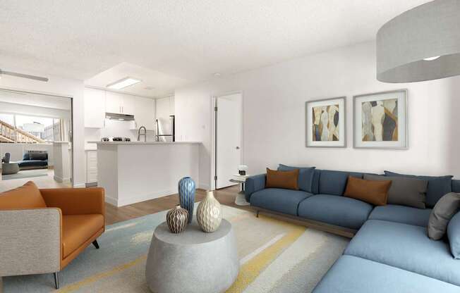 A living room with a grey couch and a grey coffee table with a blue couch and orange pillows.