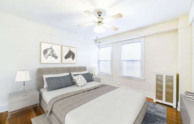 bedroom with bed, nightstands, hardwood floors, ceiling fan and large windows at wakefield hall apartments in washington dc