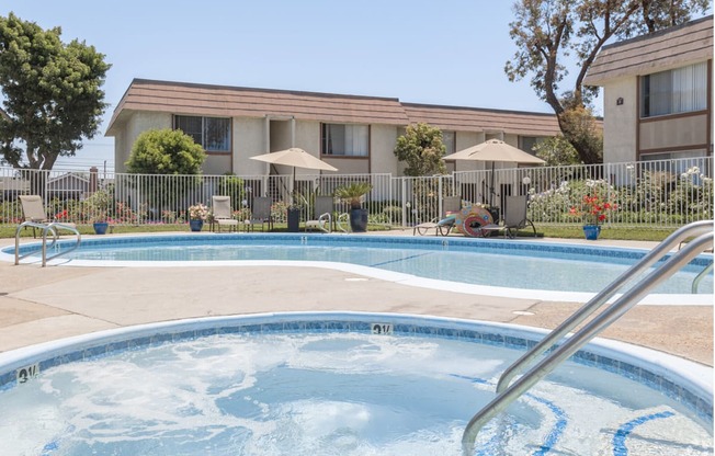 a swimming pool with a building in the background