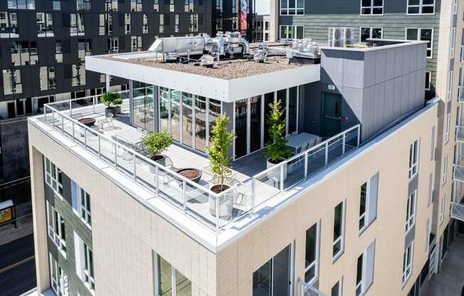 an aerial view of a large building with a rooftop terrace and plants at Slabtown Square Apartments, Oregon
