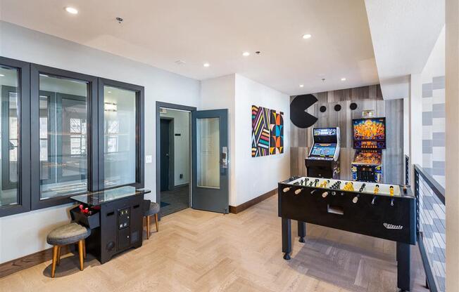 a games room with a foosball table and a video game system