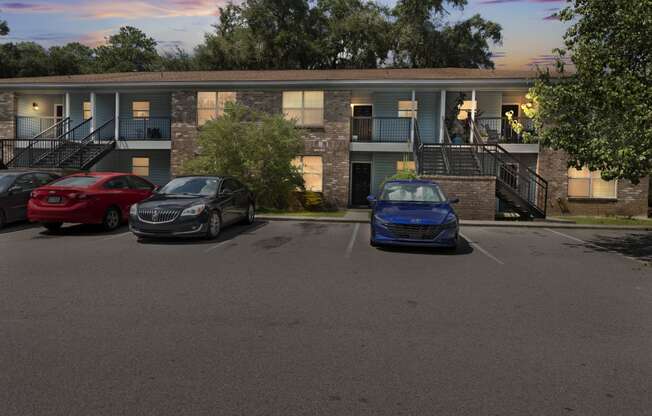 a parking lot with three cars in front of a building