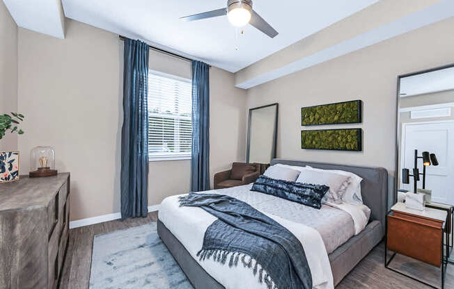 Bedrooms with hardwood-inspired flooring and ceiling fan