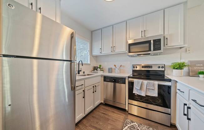 a kitchen with stainless steel appliances and white cabinets at Bay Village, Vallejo, CA, 94590