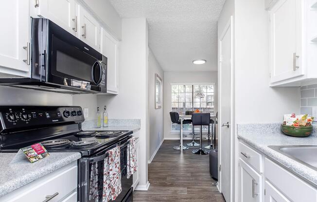 a stove top oven sitting inside of a kitchen