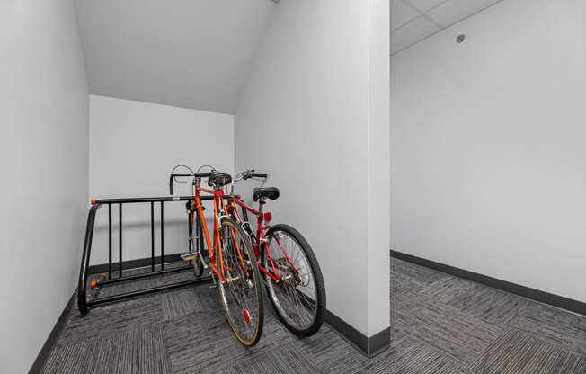 a bike rack in a white room with two bikes on it