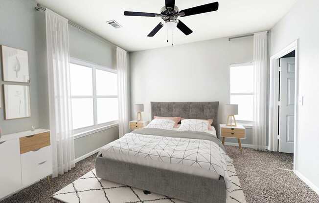 A bedroom with a large bed and a ceiling fan.