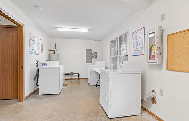 a laundry room with washers and dryers in it